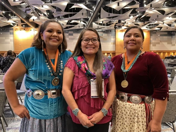 Three women smiling at the camera